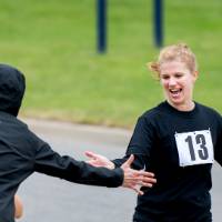 Kristen Evans excitedly high-fiving a colleague during the race